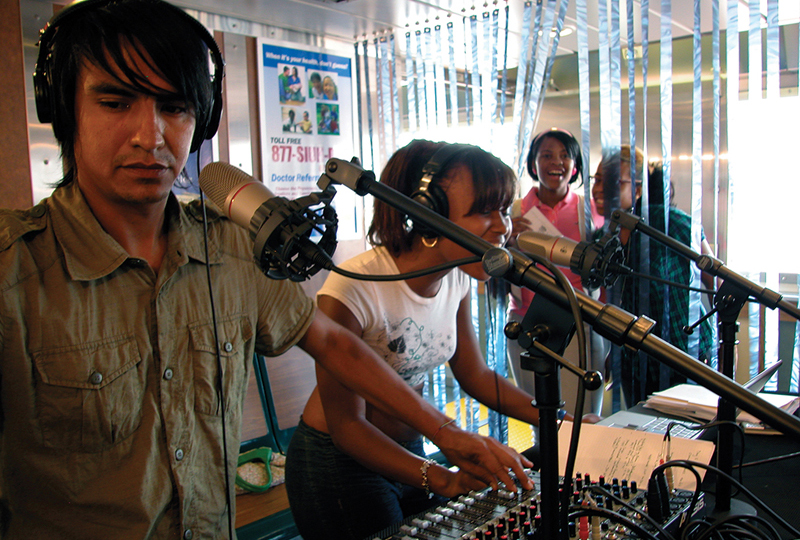 Angel Nevarez with ferry rider Sheria Washington singing an impromptu song during on-air activity, September 21, 2007.